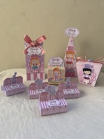 Assorted party favor boxes with festive patterns and ribbons.