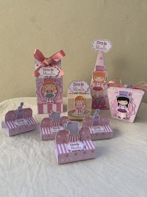 Assorted party favor boxes with festive patterns and ribbons.