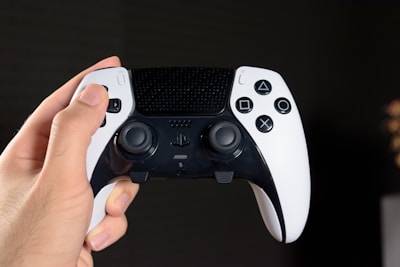 Close-up of hands holding a modern game controller in action.