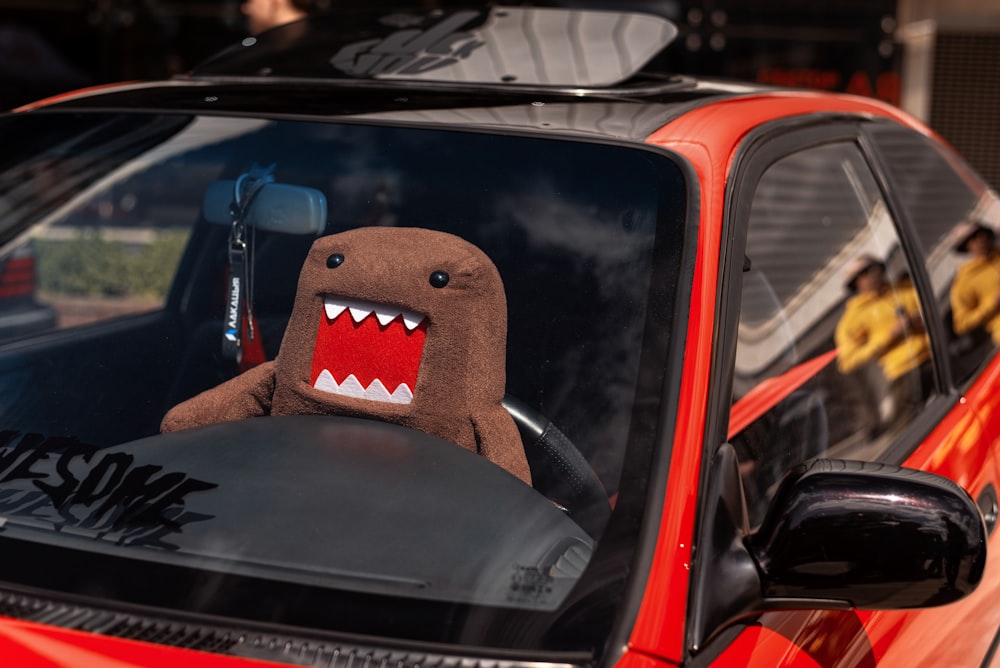 a stuffed shark is sitting in the passenger seat of a car