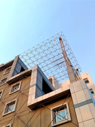 a tall building with a crane on top of it