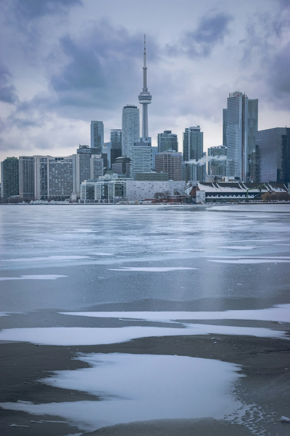 a large body of water with a city in the background