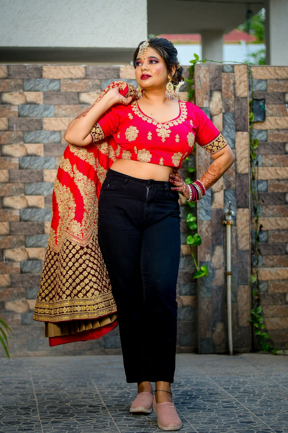 a woman in a red blouse and black pants