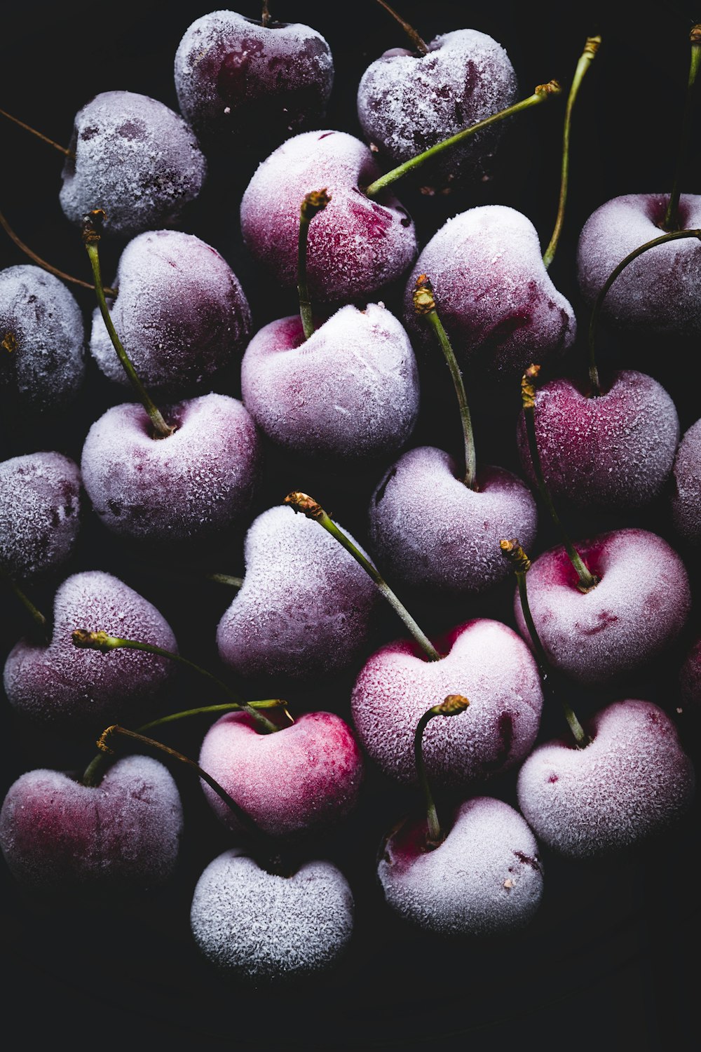 a pile of frozen cherries sitting on top of each other