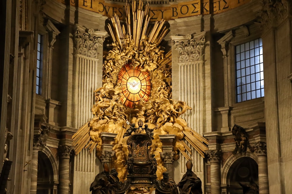 a large golden alter in a church with a stained glass window