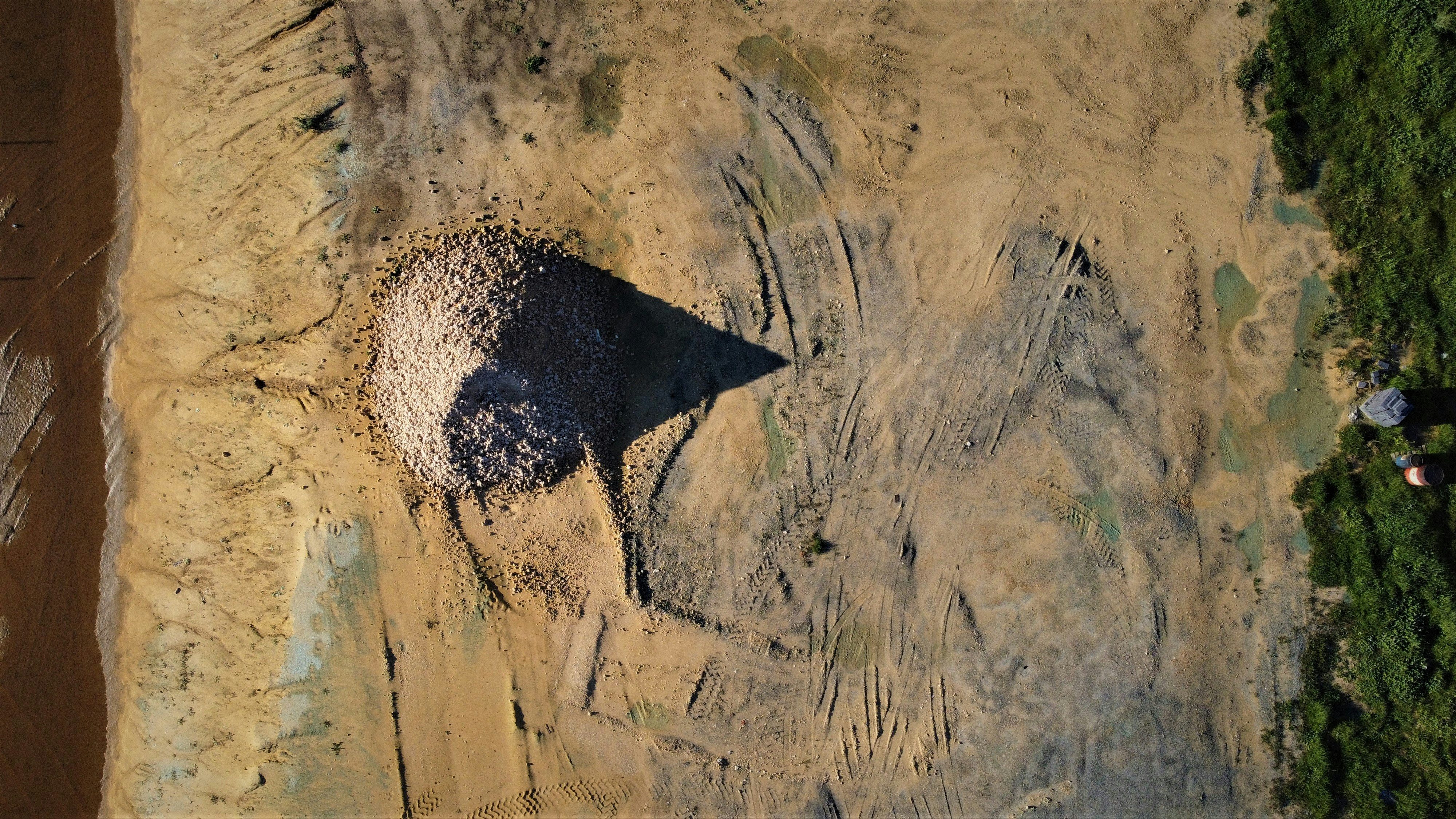 an aerial view of an elephant in a dirt field