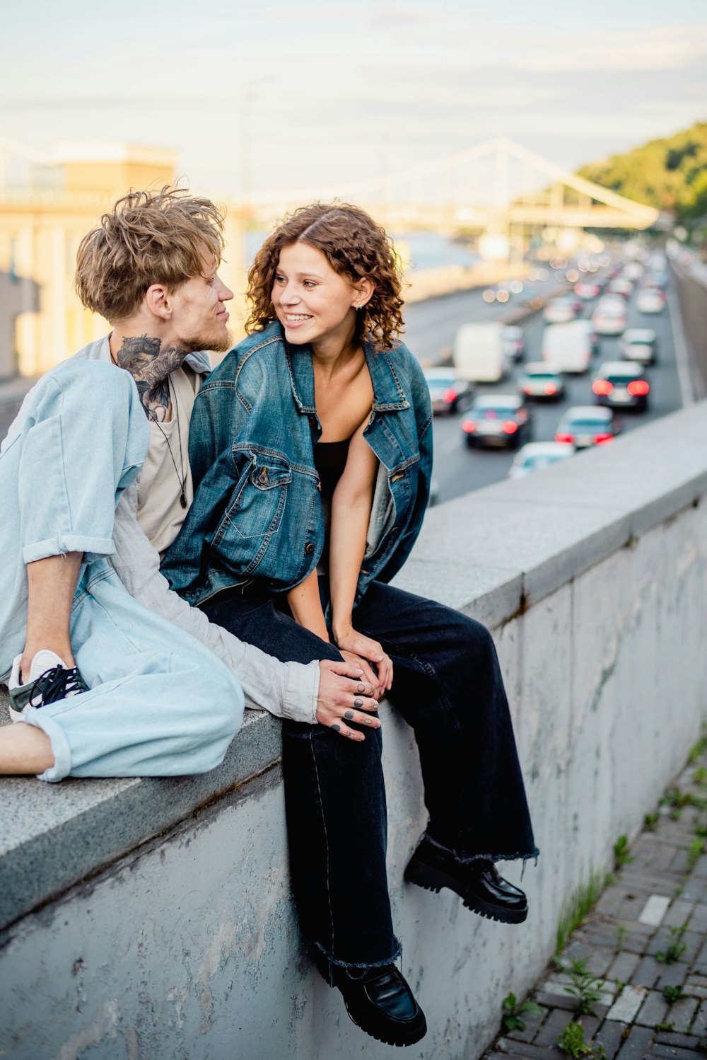 a couple of people that are sitting on a wall