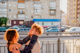 A filmmaker capturing a couple's joyful moment outdoors.