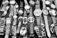 An assortment of designer watches with leather and metal bands.