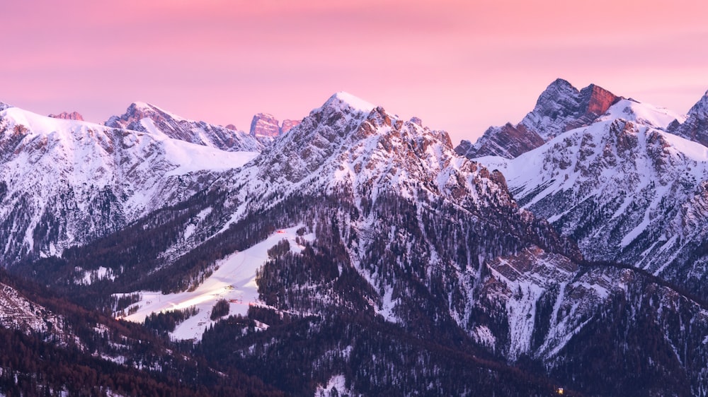 mountains covered in snow at sunset