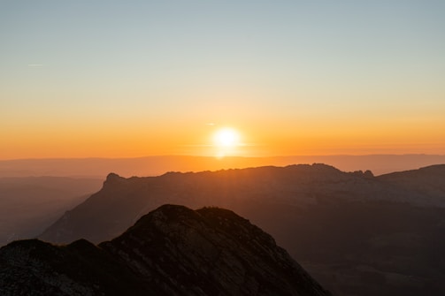 A stunning aerial shot of a mountain landscape at sunrise with vibrant colors.