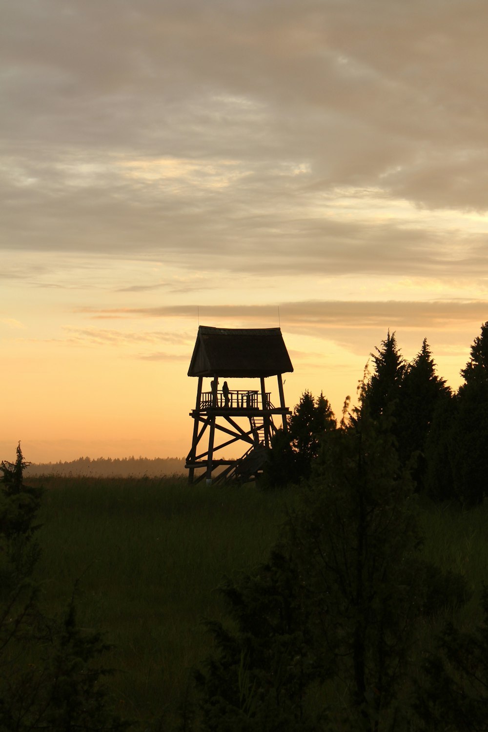 a small tower in the middle of a field