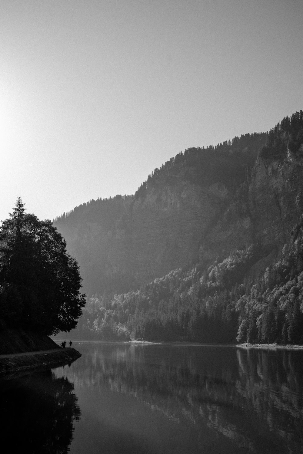 a black and white photo of a mountain lake