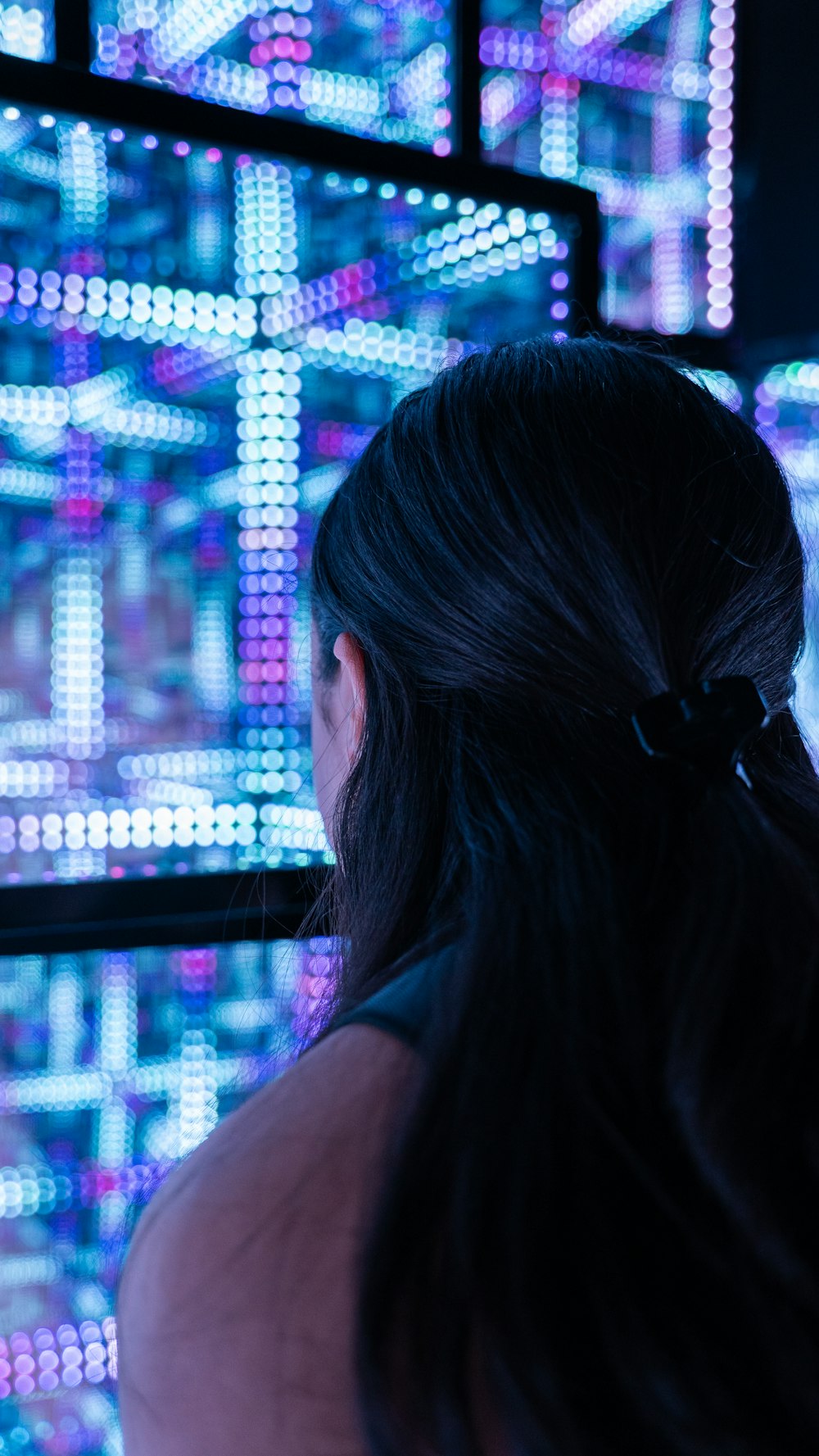 a woman standing in front of a wall of lights