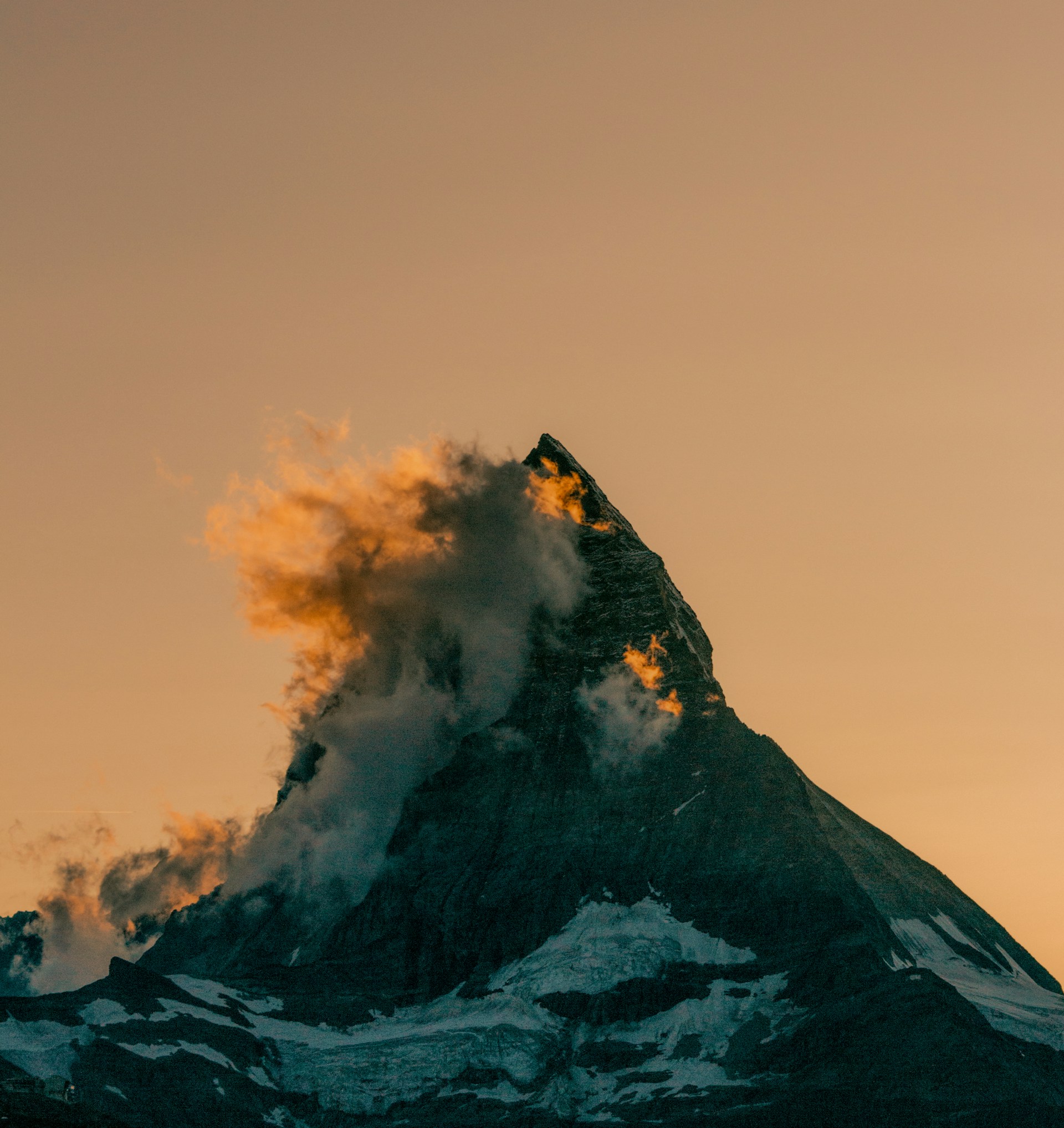 a very tall mountain with a cloud of smoke coming out of it