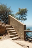 Retaining wall steps leading up to a cozy patio area surrounded by stonework.