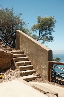 Retaining wall steps leading up to a cozy patio area surrounded by stonework.