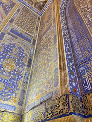Luxurious decorative interior wall featuring intricate handmade patterns with gold accents.
