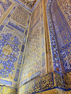 Luxurious decorative interior wall featuring intricate handmade patterns with gold accents.