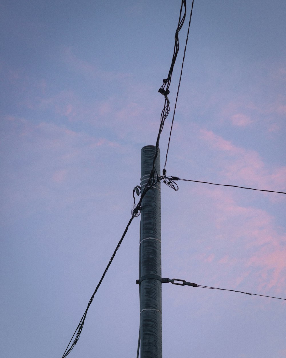 a telephone pole with a bunch of wires attached to it