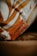 A detailed view of a textured surface featuring brown and white patterns, with a prominent leather tag embossed with the text 'Furniture'. The tag is placed on a soft fabric, contributing to a cozy aesthetic.