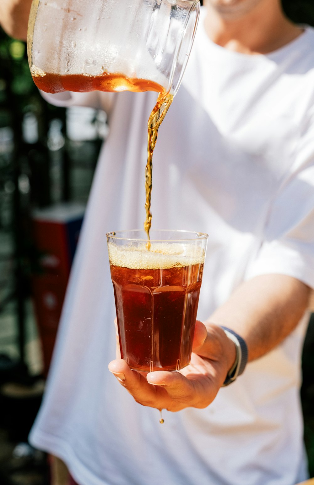 a man is pouring a drink into a glass