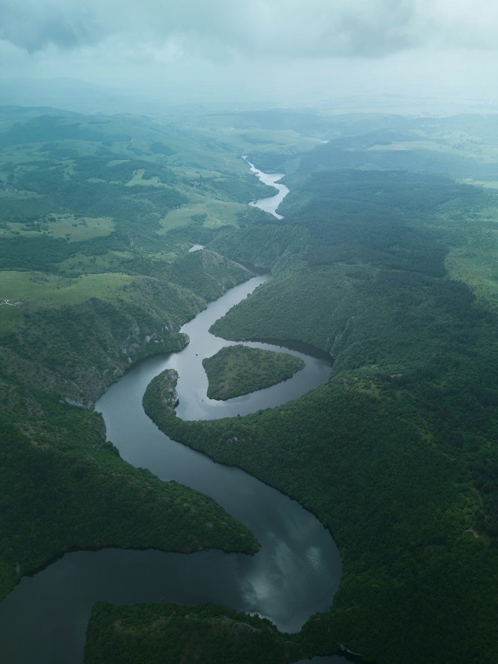 a river running through a lush green valley