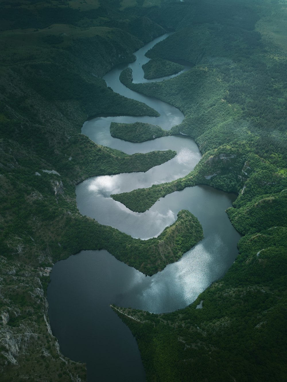 a river flowing through a lush green valley