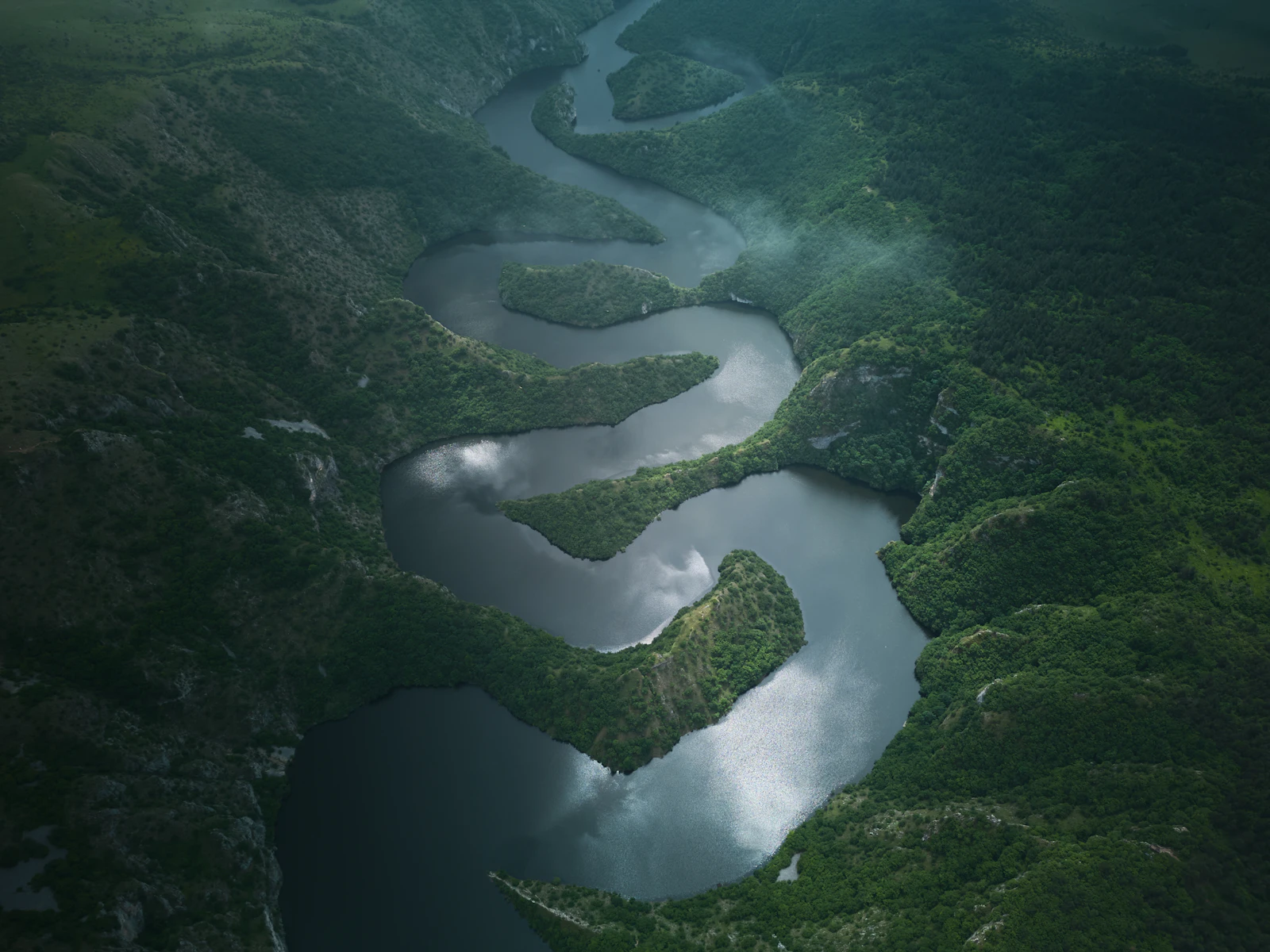 A river winding through a green valley