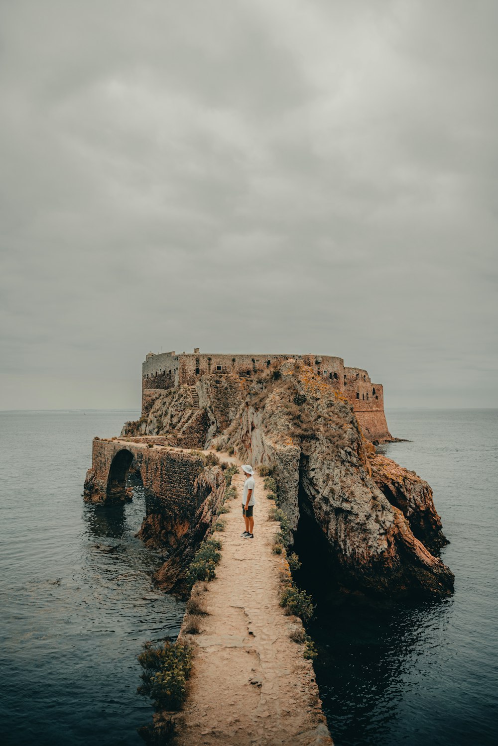 two people walking down a path to a castle