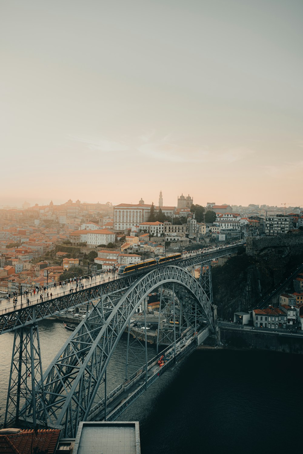 a bridge over a river with a city in the background