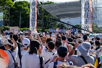 Supporters gathered around Ha Phan holding signs at a local campaign event.