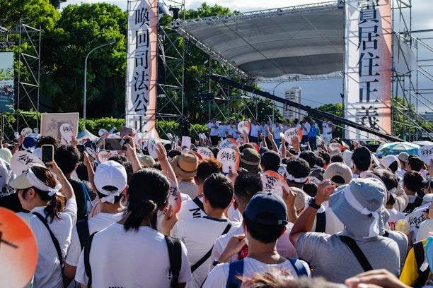 Supporters gathered around Ha Phan holding signs at a local campaign event.