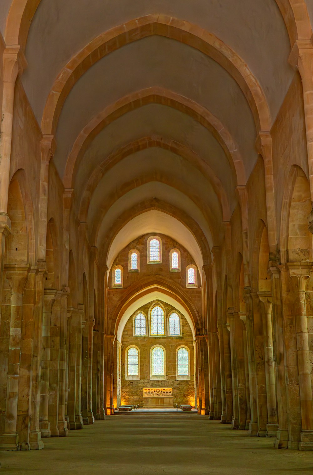 a large cathedral with stone columns and arches