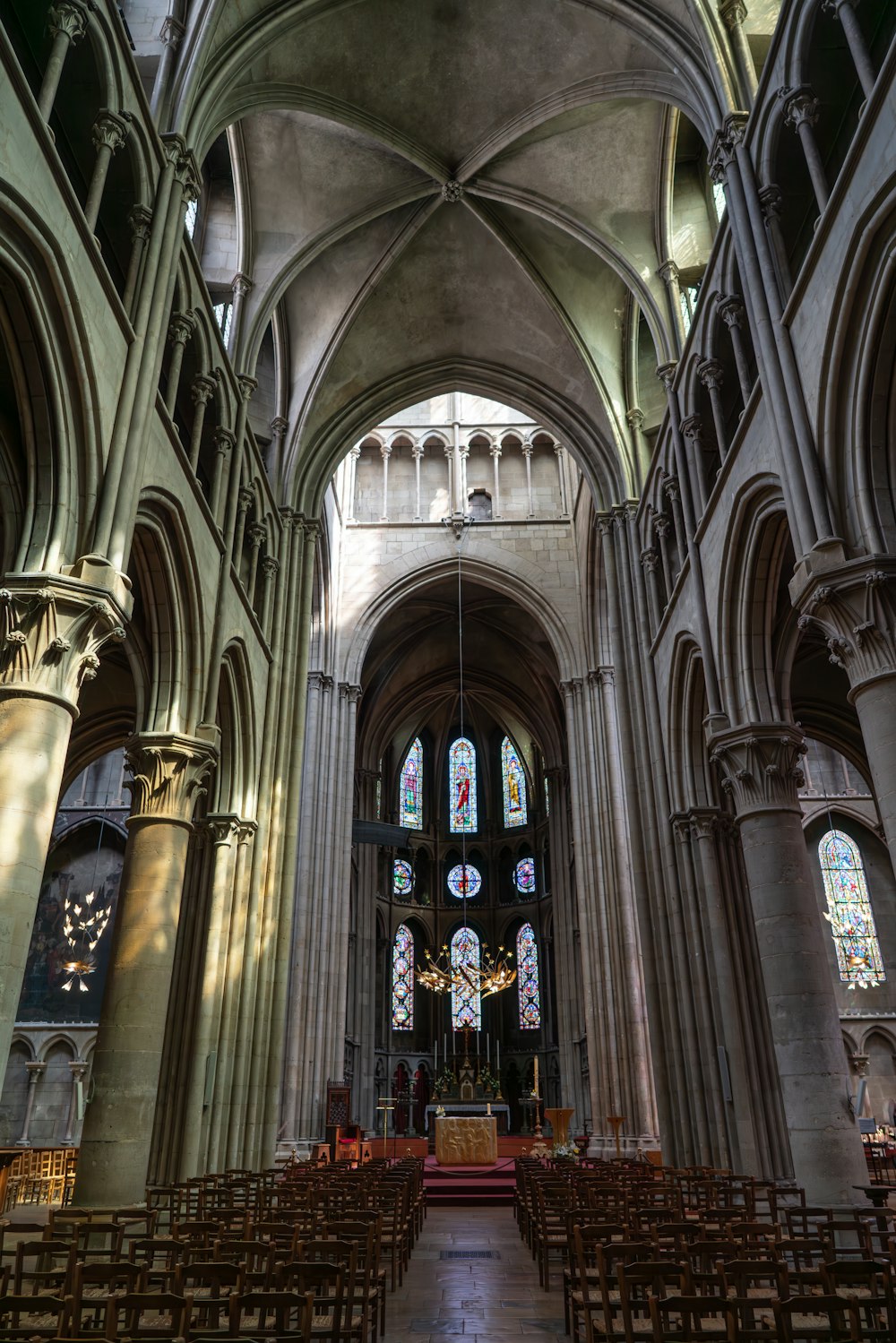 a large cathedral with stained glass windows and pews