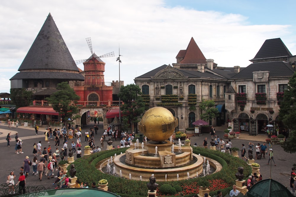 a crowd of people walking around a town square