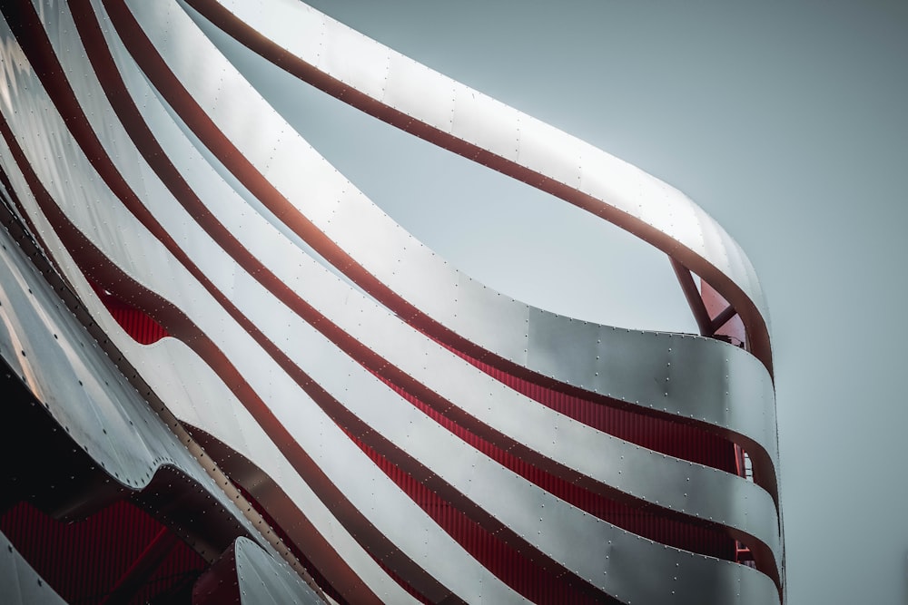 a close up of a structure with a red and white stripe on it