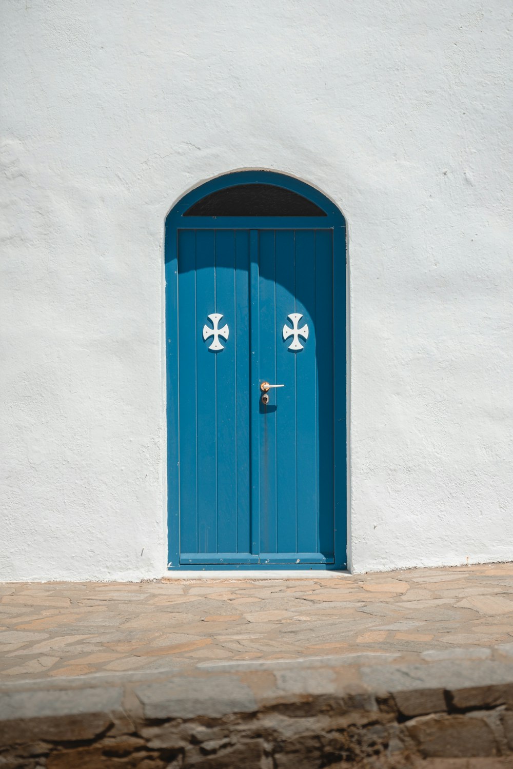 a white building with a blue door and window