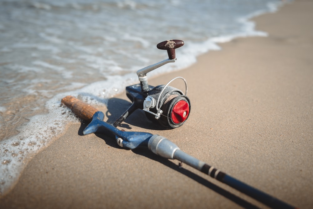 a fishing rod and reel on the beach