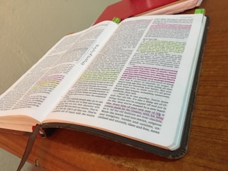 an open book sitting on top of a wooden table