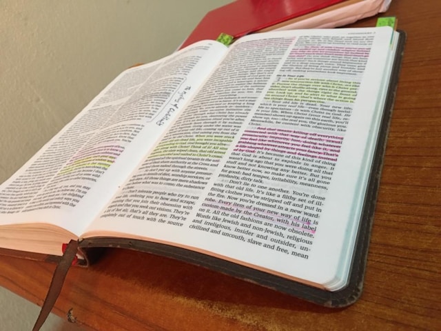 an open book sitting on top of a wooden table