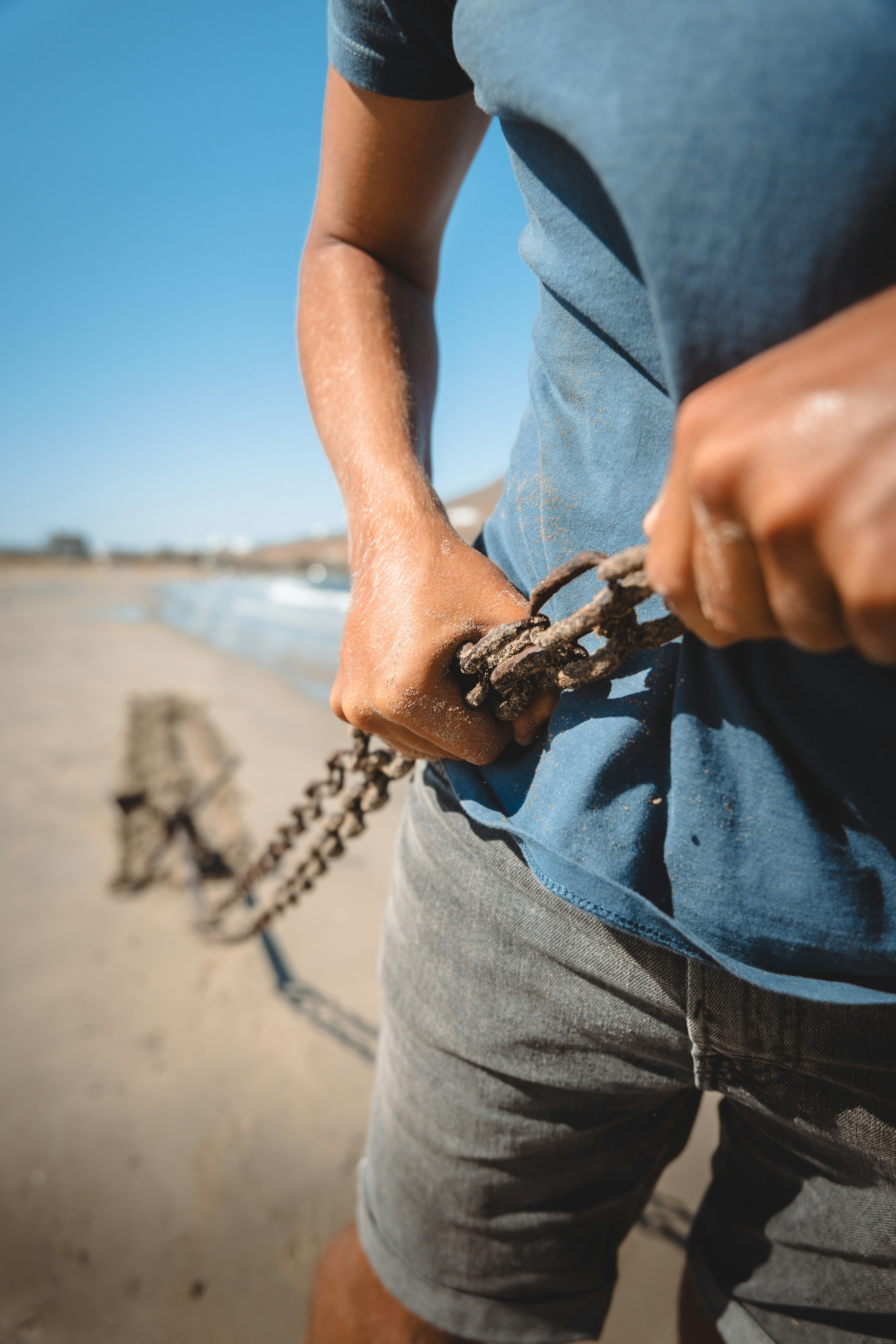 Un hombre sosteniendo una cadena en la playa