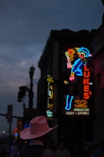 A glowing neon silhouette of the cosmic sheriff against a starry retro-futuristic cityscape.