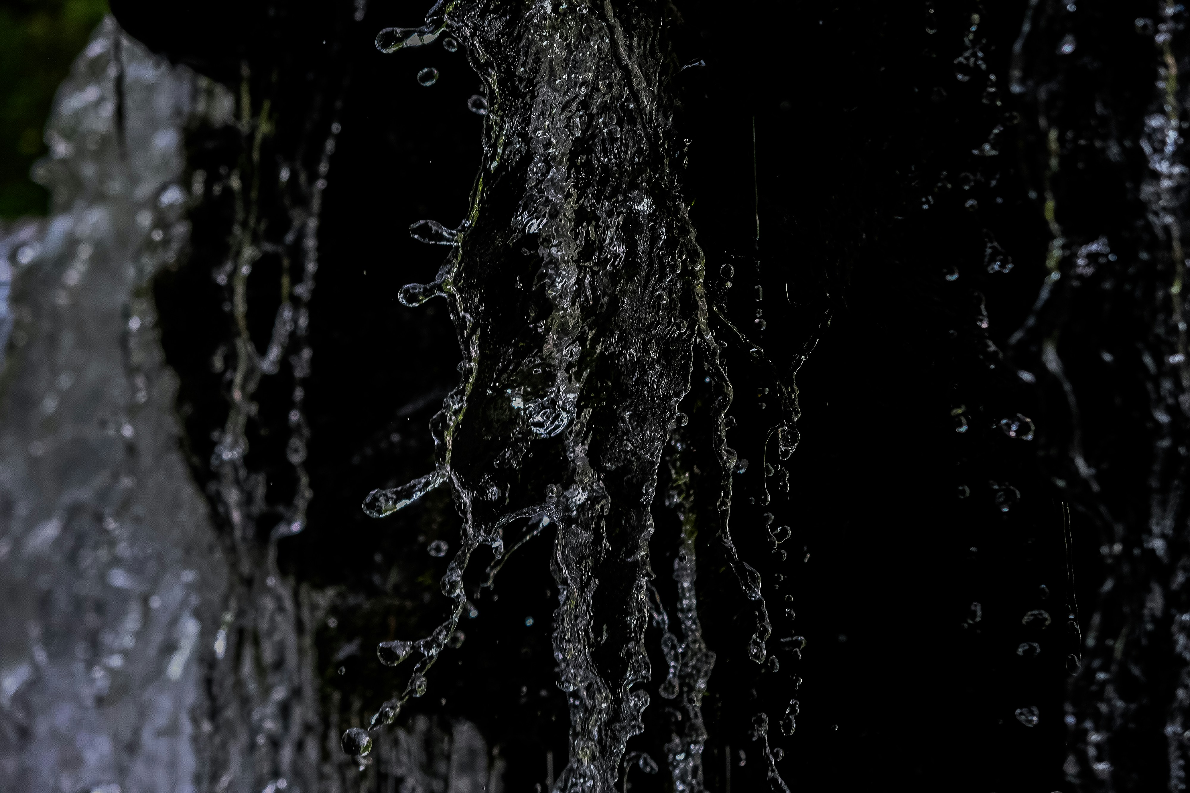 a close up of a waterfall with water coming out of it
