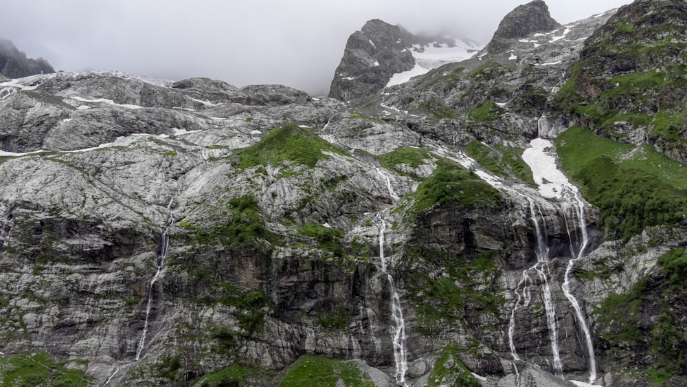 a very tall mountain with a waterfall in the middle of it