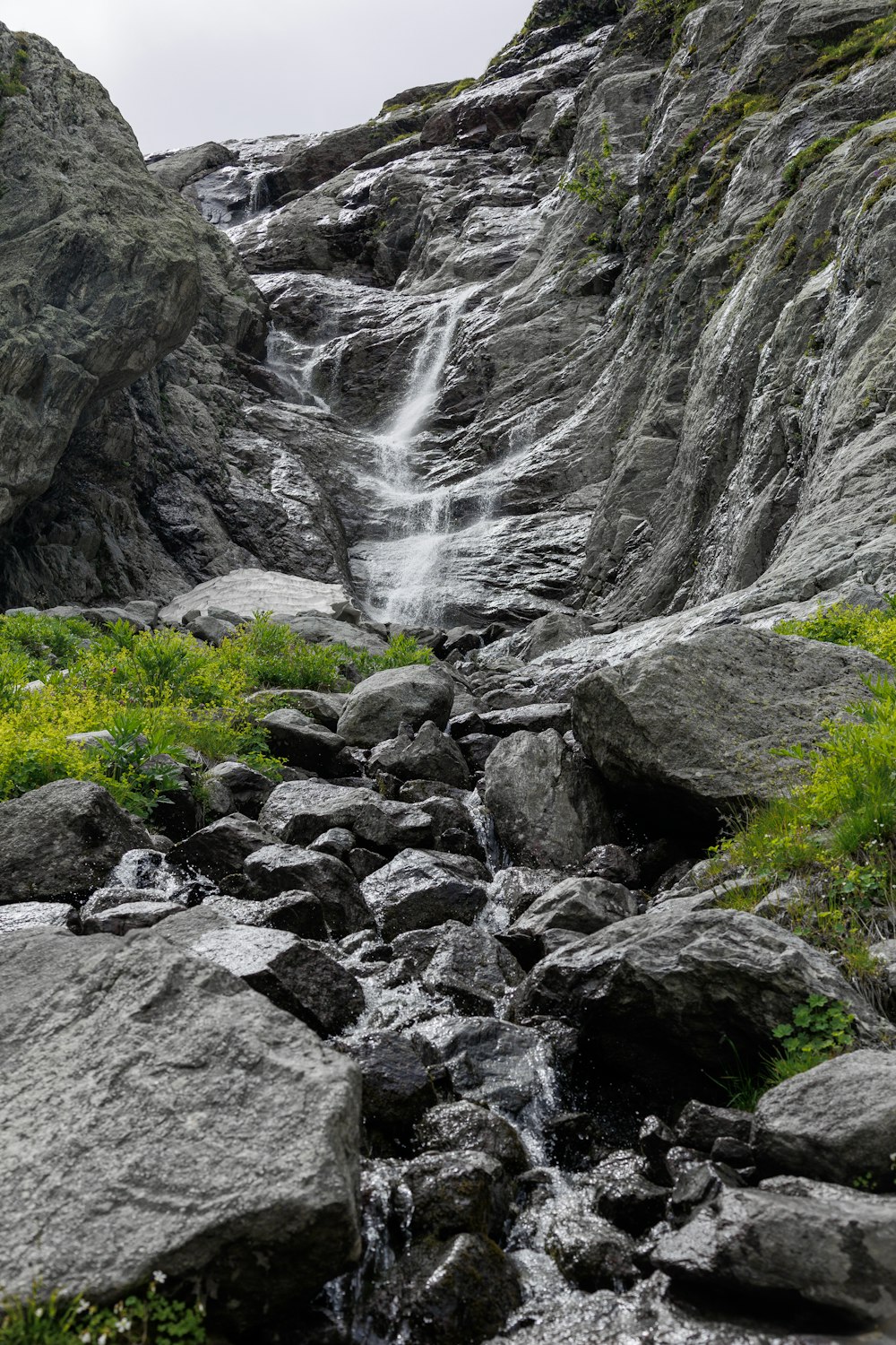 a stream of water running between two large rocks