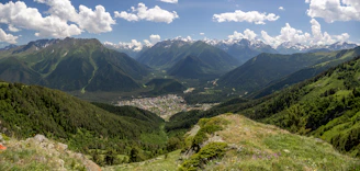 A panoramic shot from Zugerberg mountain showing lush green hills and the town below
