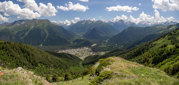 A panoramic shot from Zugerberg mountain showing lush green hills and the town below