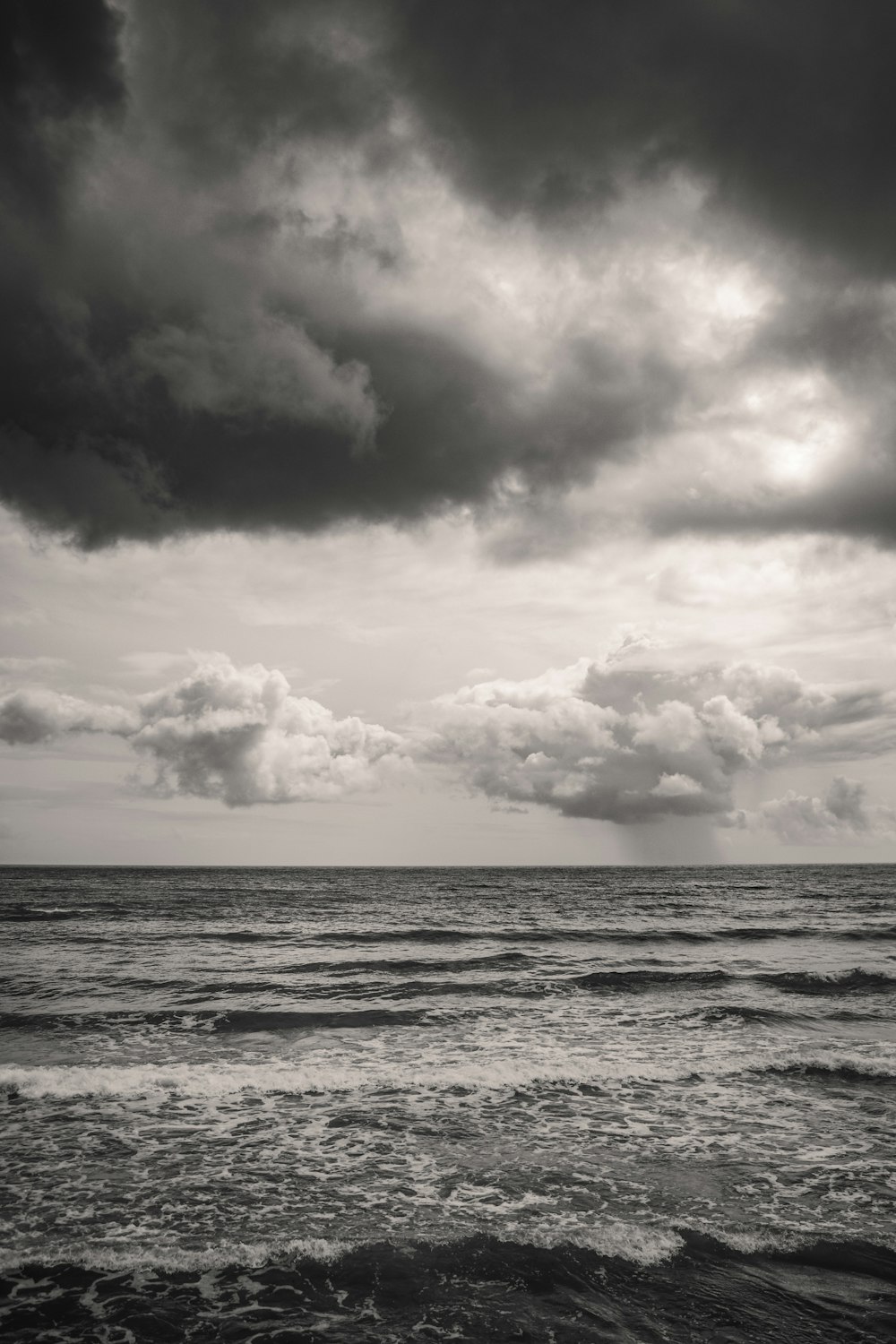 a black and white photo of the ocean