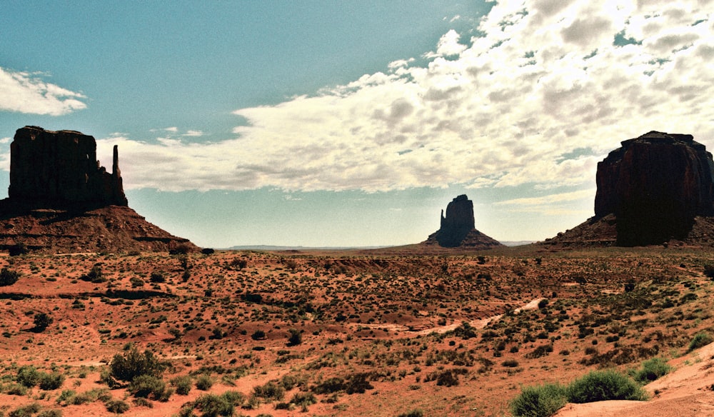 a view of a desert with a few rocks in the distance